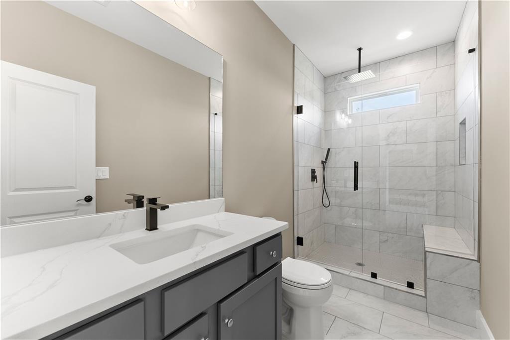 2275 Dr Bramblett Road Cumming, GA 30028 - Photo 47 of 78 a bathroom with a sink a toilet a mirror and shower