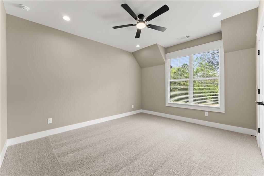 2275 Dr Bramblett Road Cumming, GA 30028 - Photo 53 of 78 en empty room with windows and ceiling fan