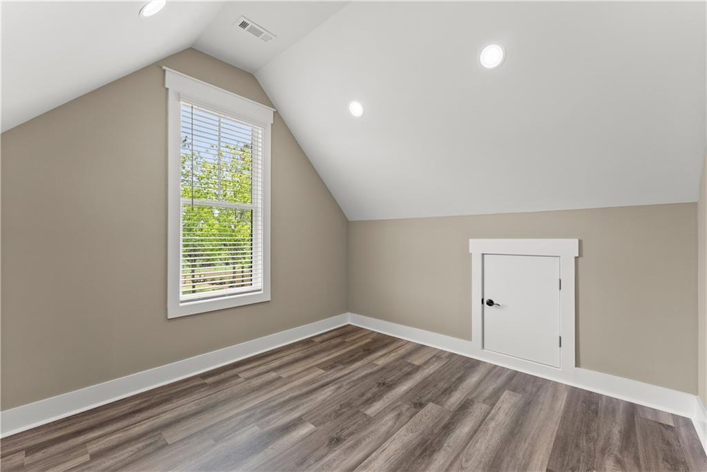 2275 Dr Bramblett Road Cumming, GA 30028 - Photo 59 of 78 an empty room with wooden floor and windows