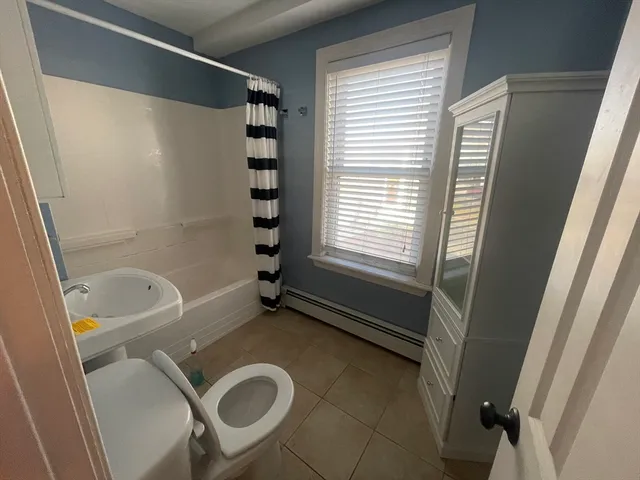 a bathroom with a tub a sink and a shower