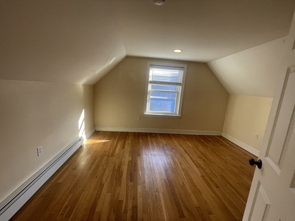 363 Shrewsbury Street, Unit 2 Worcester, MA 01604 - Photo 10 of 20 a view of an empty room with wooden floor and a window