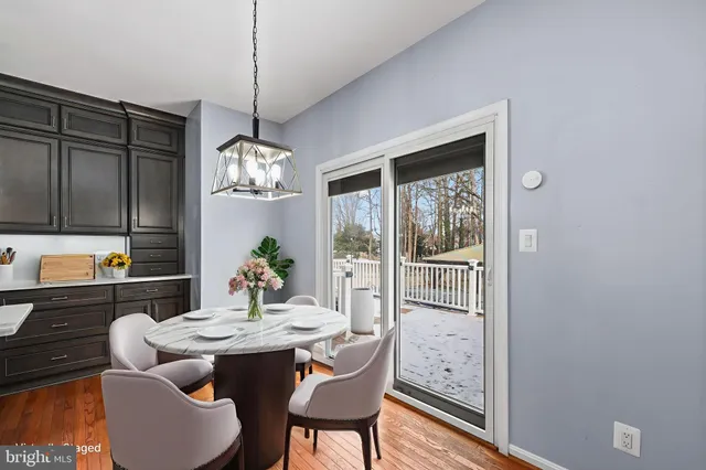 a dining room with furniture a chandelier and window