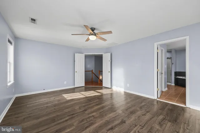 a view of room with hardwood floor and ceiling fan