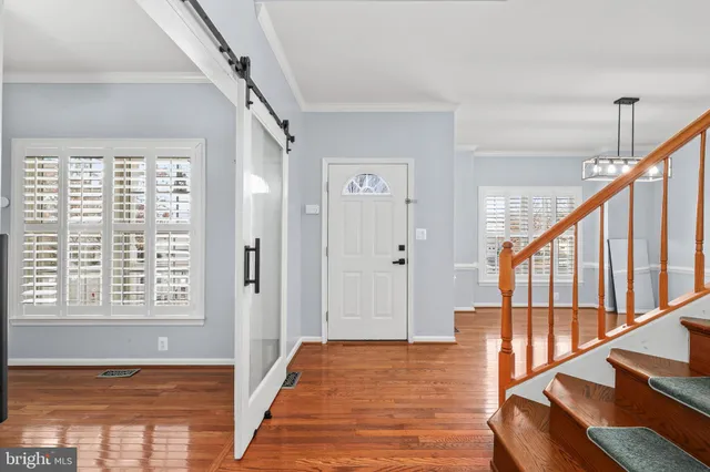 a view of an entryway with wooden floor