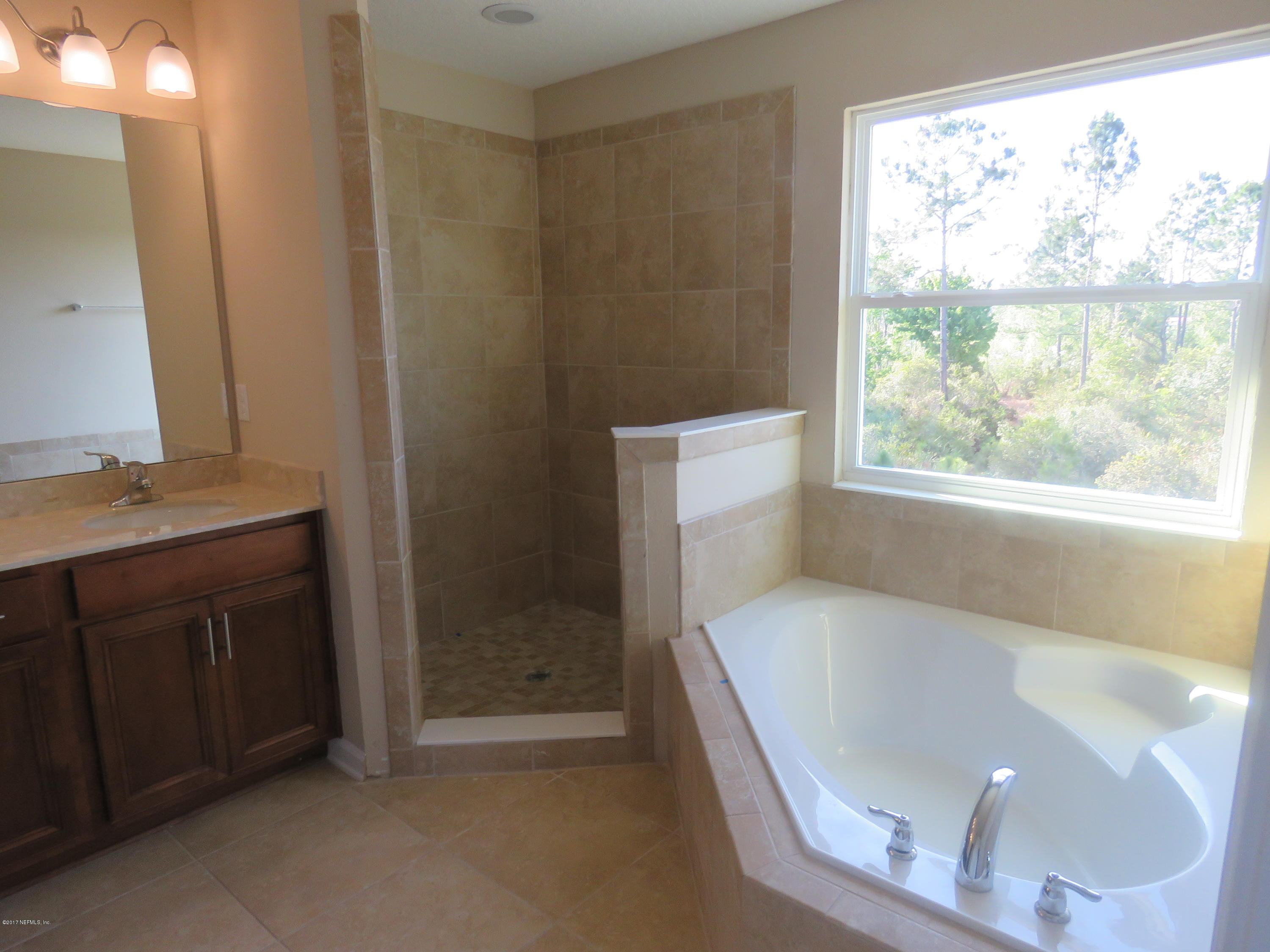 607 Deer Crossing Road St. Augustine, FL 32086 - Photo 26 of 28 a bathroom with a bathtub and a sink