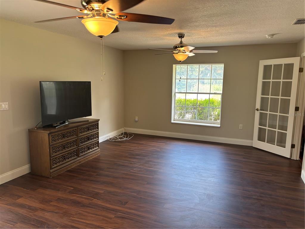 4641 Highway 98 Fort Meade, FL 33841 - Photo 11 of 14 an empty room with wooden floor fan and windows