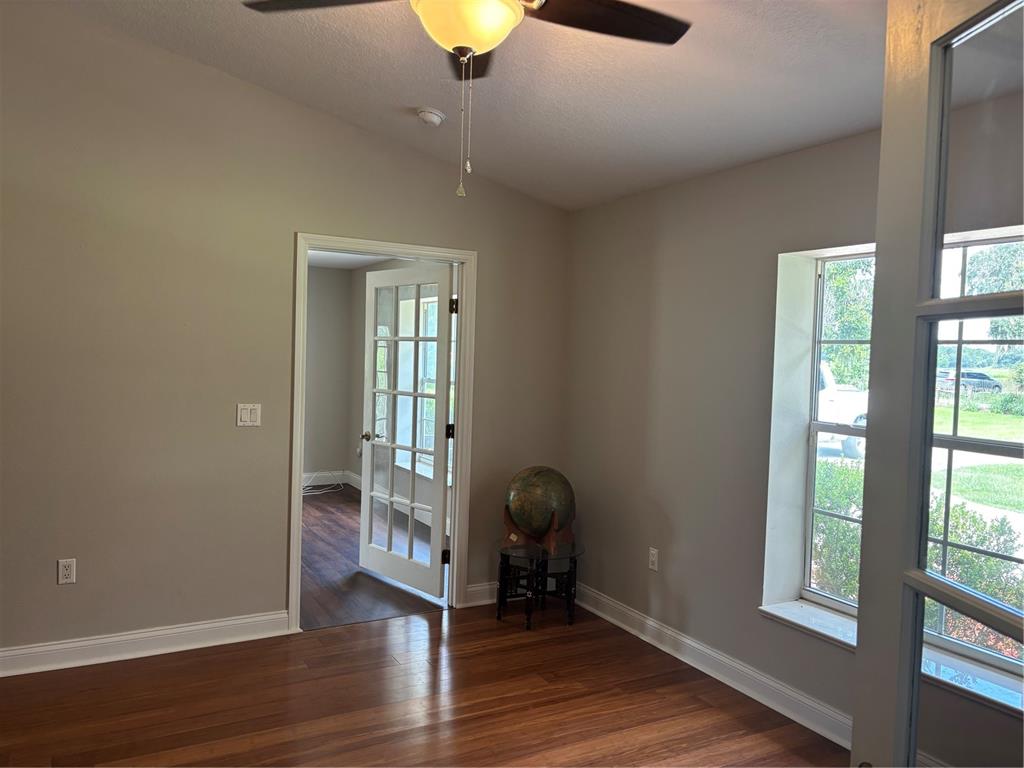 4641 Highway 98 Fort Meade, FL 33841 - Photo 5 of 14 an empty room with wooden floor and windows