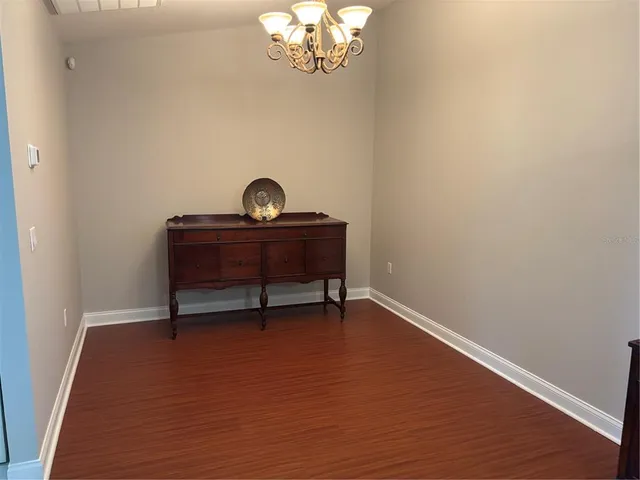 a view of a workspace with furniture and chandelier