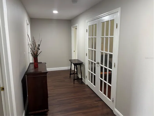 a view of a hallway with wooden floor and entryway