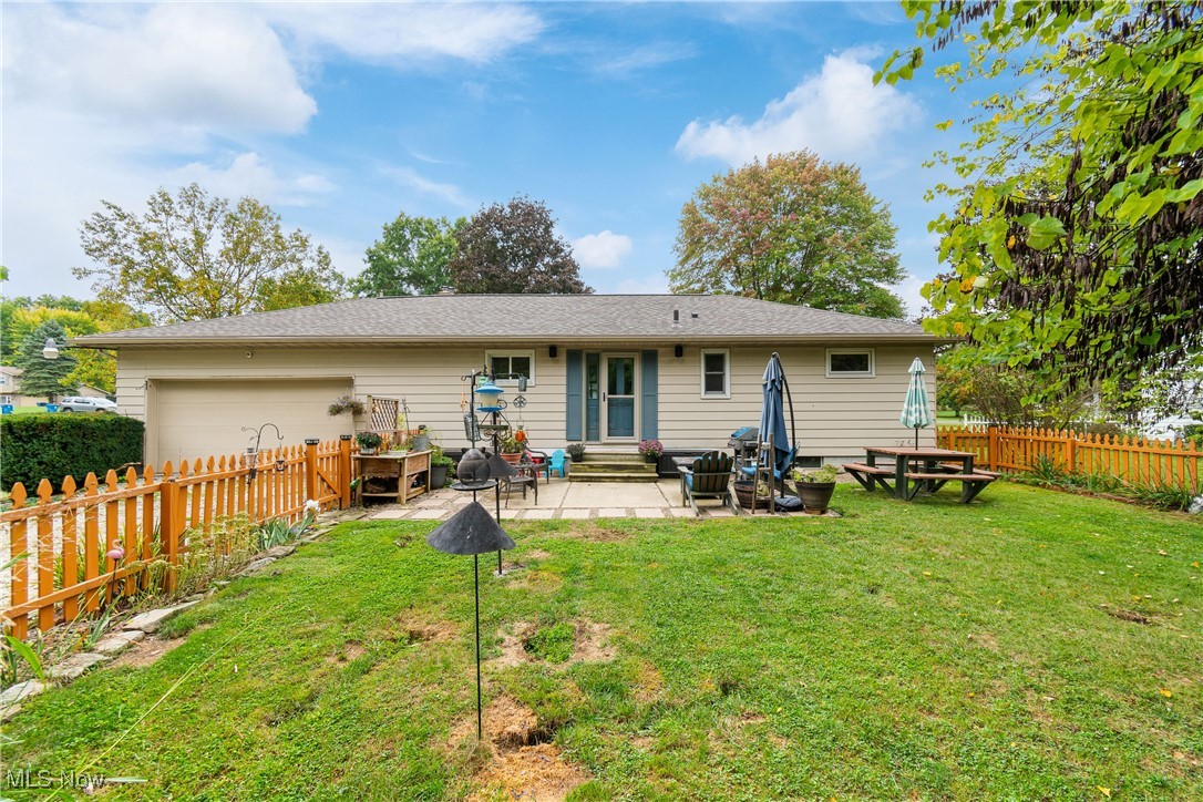 3341 Brenner Road Barberton, OH 44203 - Photo 23 of 30 Back of house with a lawn, a fire pit, and a patio area