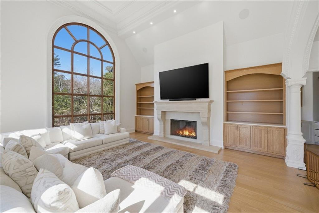 10450 Belladrum Alpharetta, GA 30022 - Photo 27 of 95 a living room with furniture a fireplace and a flat screen tv