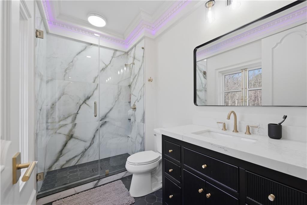 10450 Belladrum Alpharetta, GA 30022 - Photo 38 of 95 a bathroom with a granite countertop sink toilet and shower
