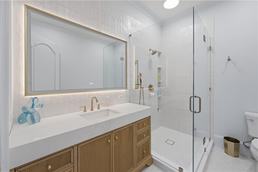10450 Belladrum Alpharetta, GA 30022 - Photo 41 of 95 a bathroom with a sink a toilet and shower