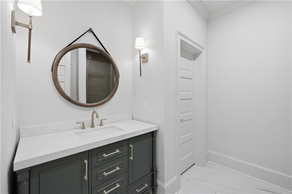 10450 Belladrum Alpharetta, GA 30022 - Photo 48 of 95 a bathroom with a sink a vanity and a mirror