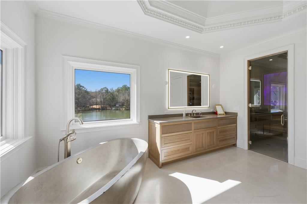 10450 Belladrum Alpharetta, GA 30022 - Photo 75 of 95 a bathroom with a tub a double vanity sink a mirror and a bathtub