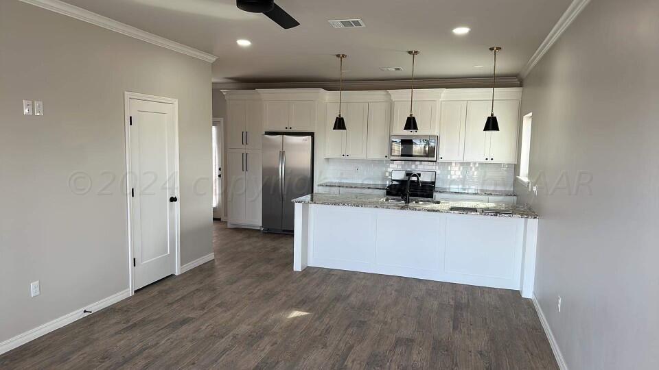 14007 Hawksbeard Place Amarillo, TX 79119 - Photo 2 of 18 a kitchen with stainless steel appliances granite countertop a refrigerator and a stove top oven