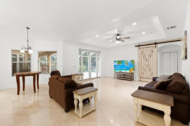 an empty room with windows and chandelier