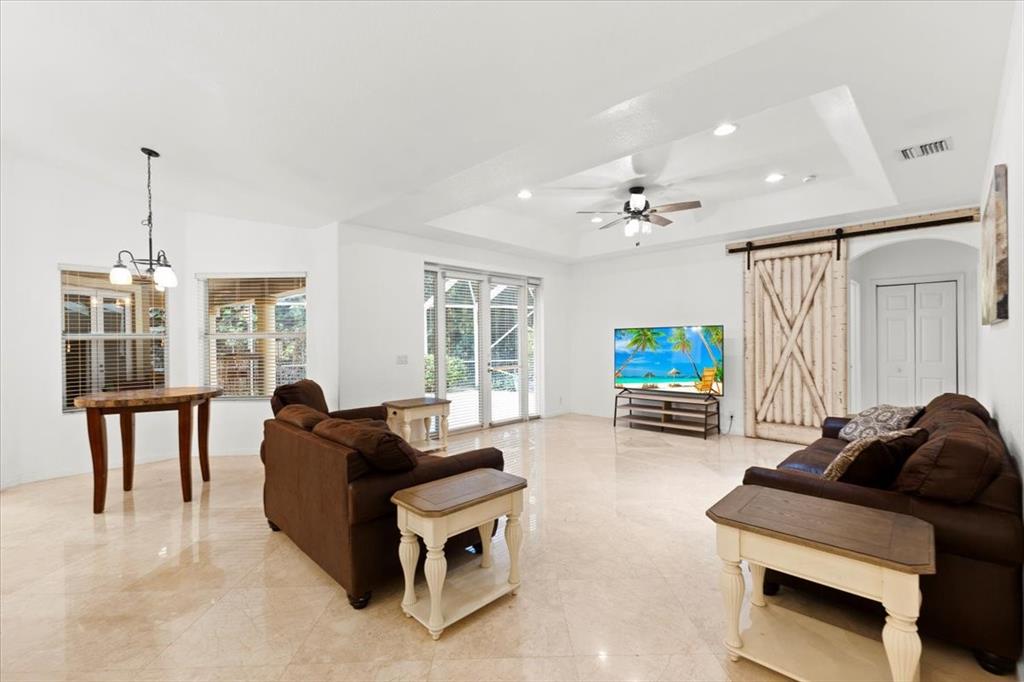 Undisclosed Address Davie, FL 33314 - Photo 14 of 38 a living room with furniture a flat screen tv and a large window