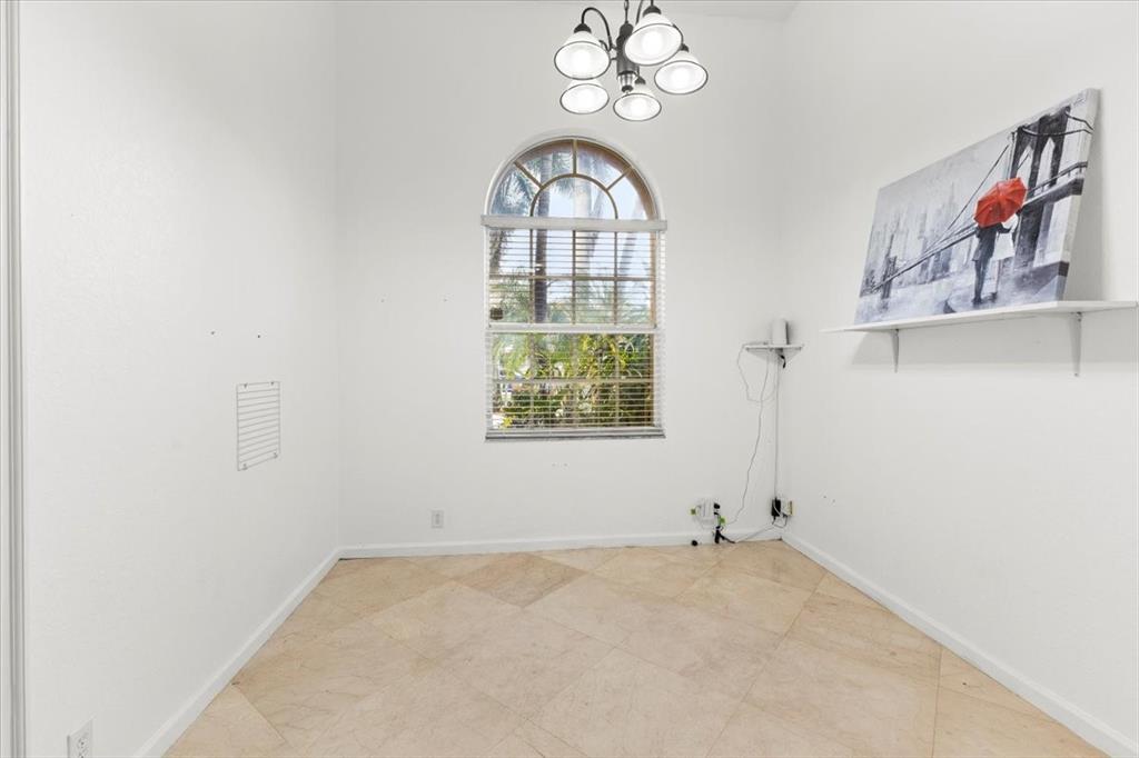 Undisclosed Address Davie, FL 33314 - Photo 16 of 38 an empty room with a window and a chandelier