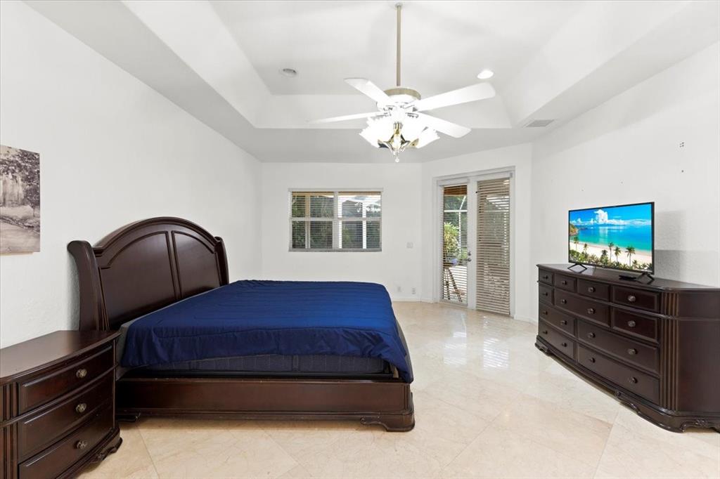 Undisclosed Address Davie, FL 33314 - Photo 18 of 38 a bedroom with a bed and a flat screen tv