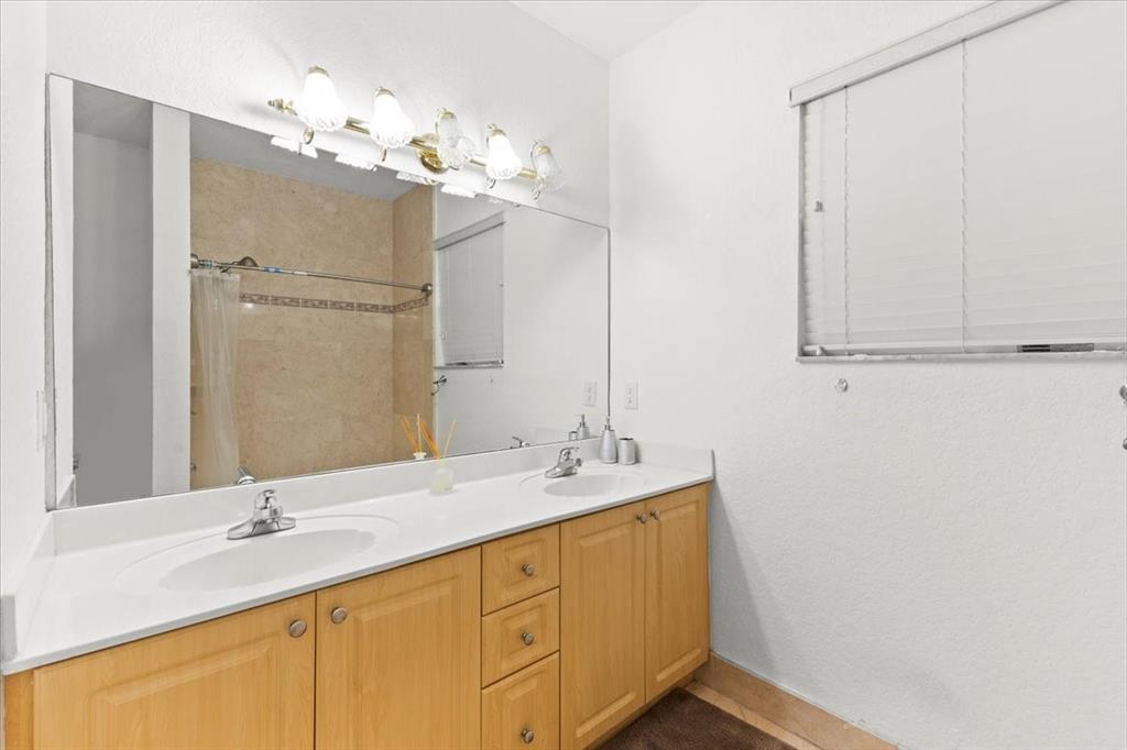 Undisclosed Address Davie, FL 33314 - Photo 23 of 38 a bathroom with a double vanity sink and a mirror