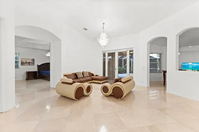 a spacious bedroom with a bed and glass door