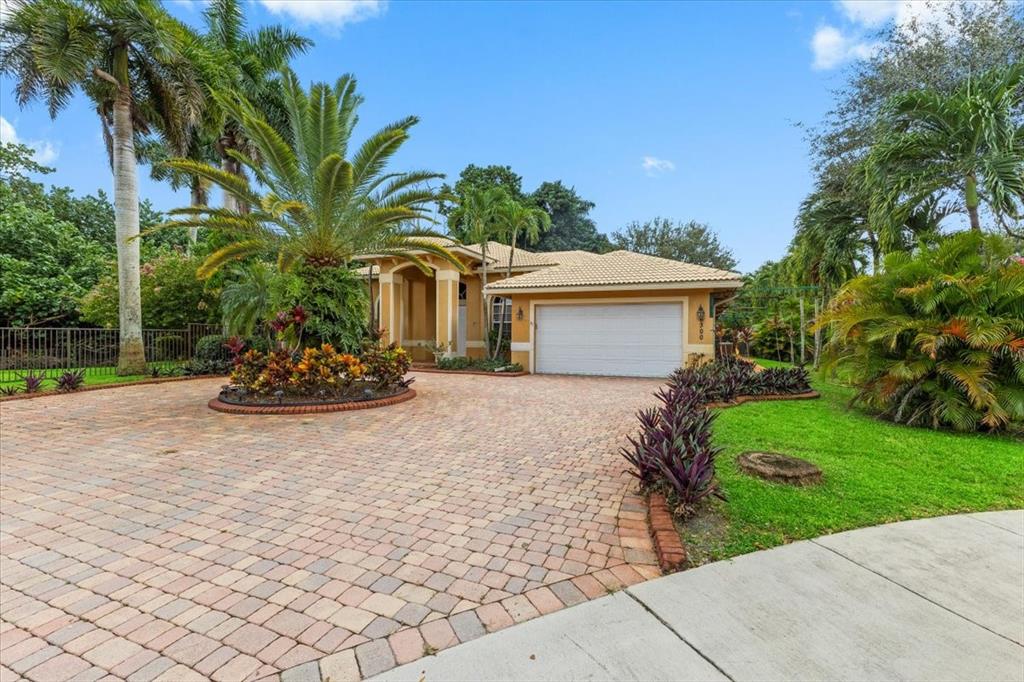 Undisclosed Address Davie, FL 33314 - Photo 31 of 38 a front view of a house with a yard and a garage