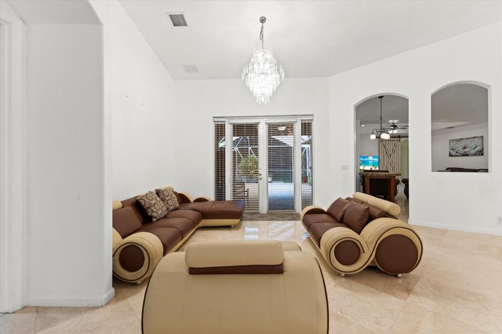 Undisclosed Address Davie, FL 33314 - Photo 4 of 38 a living room with furniture and a chandelier