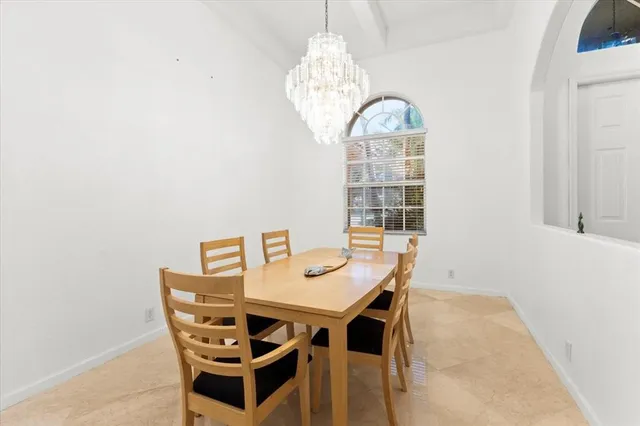 a view of a dining room with furniture and chandelier