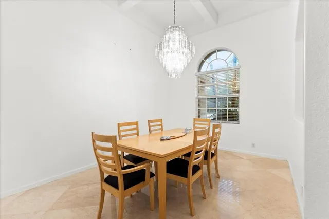 a kitchen with white cabinets and appliances
