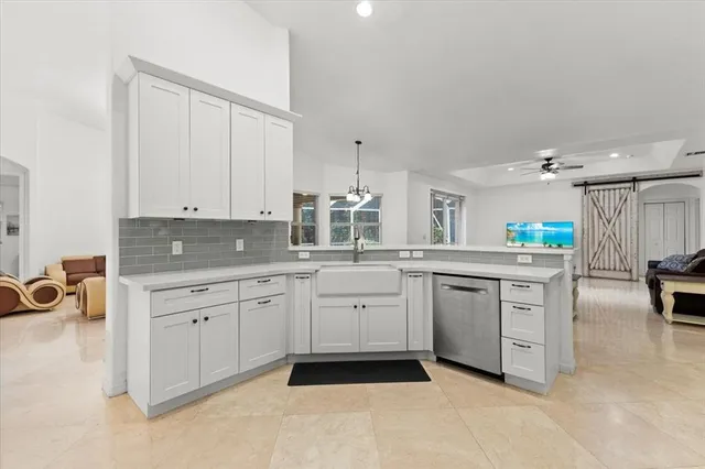 a kitchen with a sink stainless steel appliances and counter space