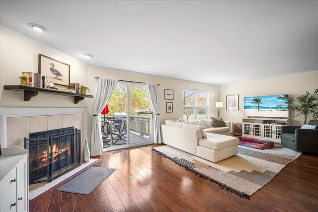 a living room with furniture large window and a fireplace
