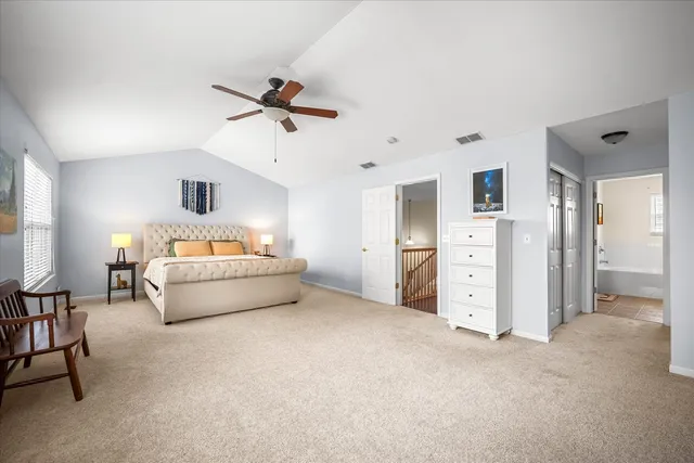 a bedroom with furniture and a ceiling fan