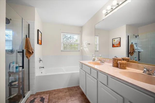 a bathroom with a tub sink and mirror