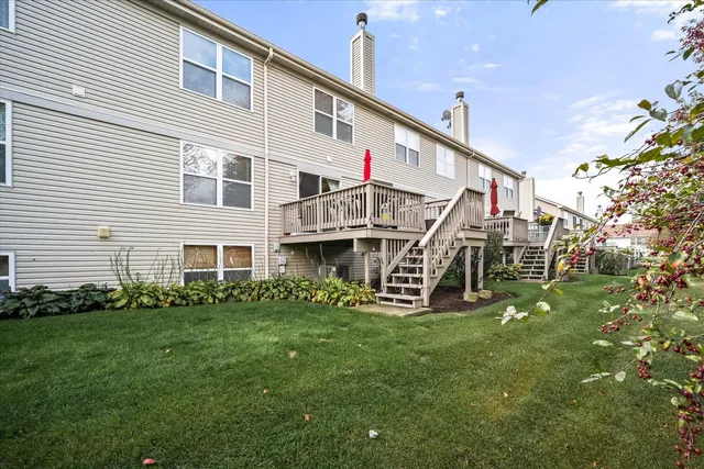 a view of a house with a yard and sitting area
