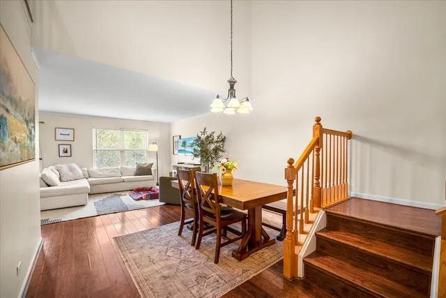 a view of a dining room with furniture wooden floor and chandelier
