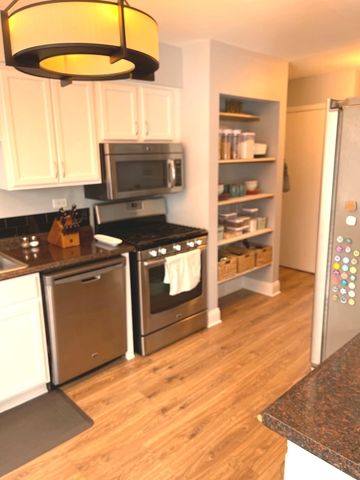 a kitchen with a window a sink and a stove