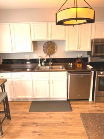 a kitchen with stainless steel appliances a stove a sink and a microwave