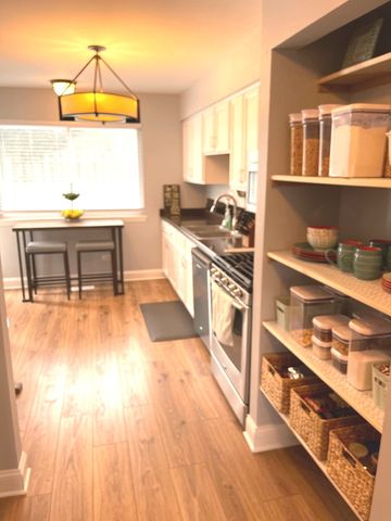 a living room with a flat screen tv and a floor to ceiling window