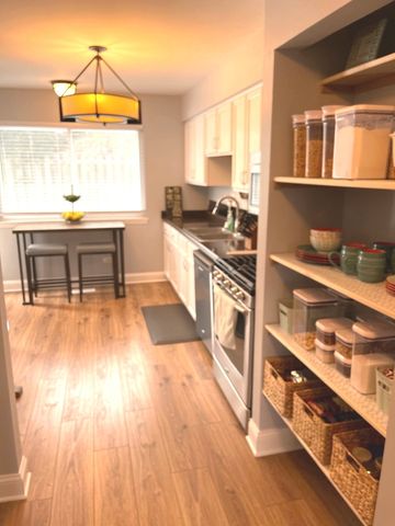 a kitchen with stainless steel appliances granite countertop a stove and a refrigerator