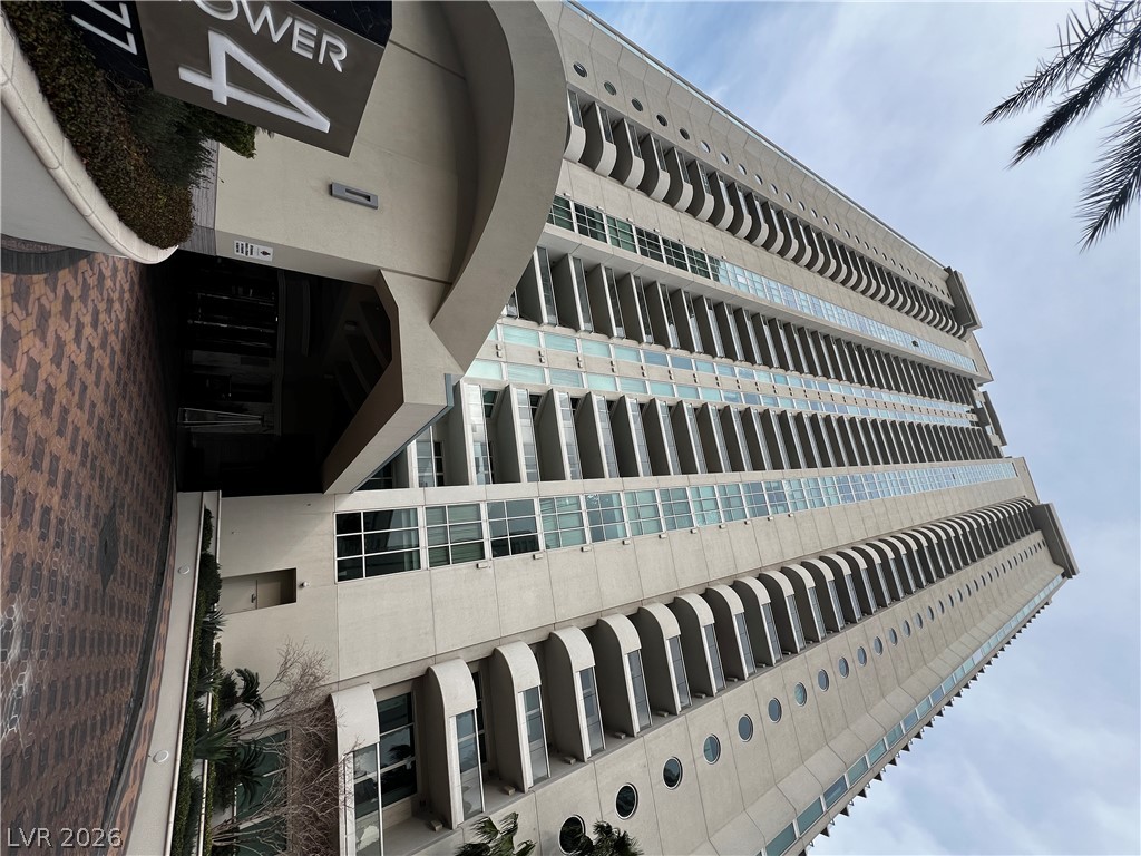 2777 Paradise Road, Unit 1603 Las Vegas, NV 89109 - Photo 2 of 4 A striking modern skyscraper with numerous windows and architectural details ascends towards the sky.