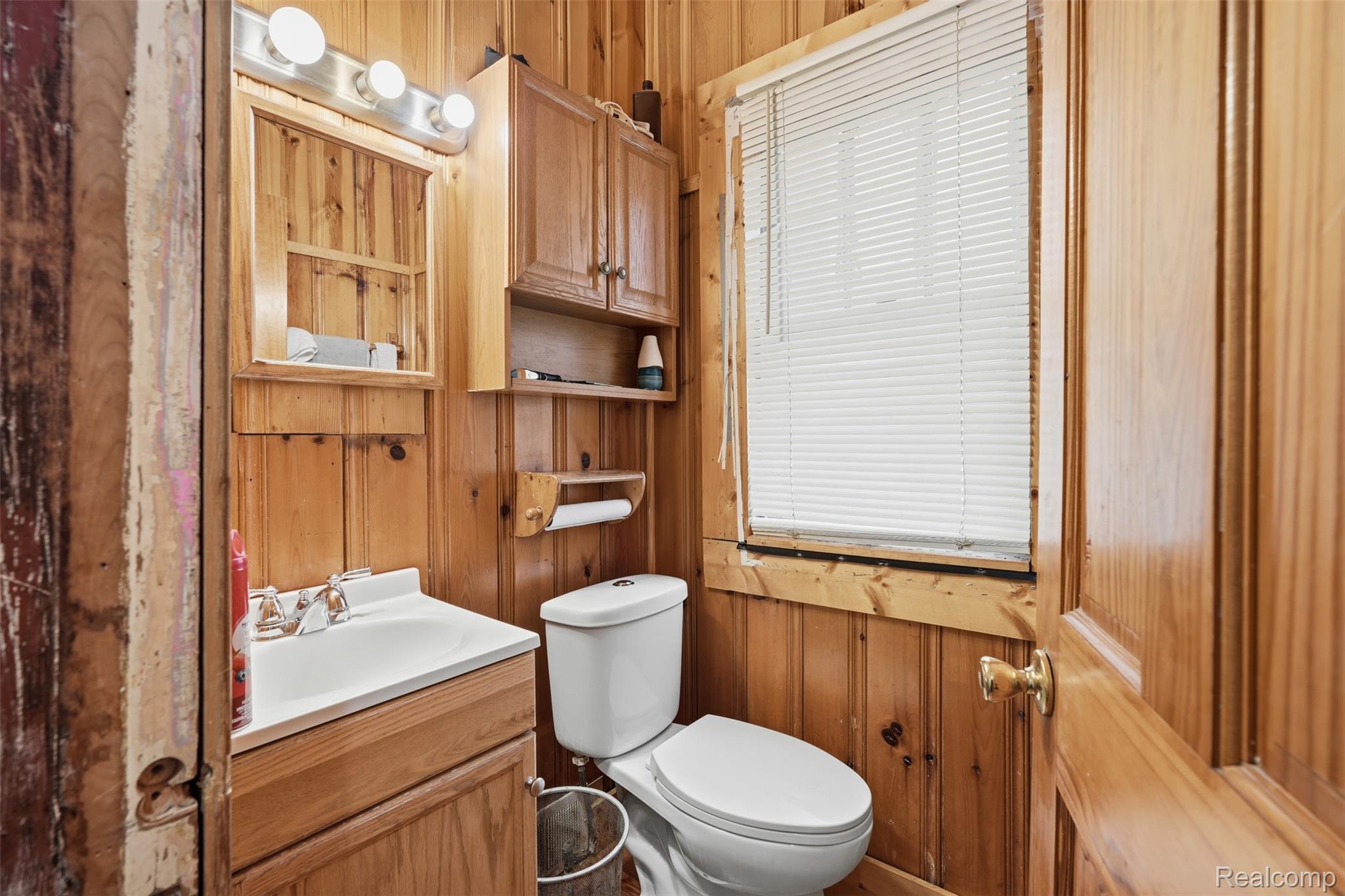 2500 Atkinson Street Detroit, MI 48206 - Photo 9 of 21 Bathroom featuring wood walls and vanity