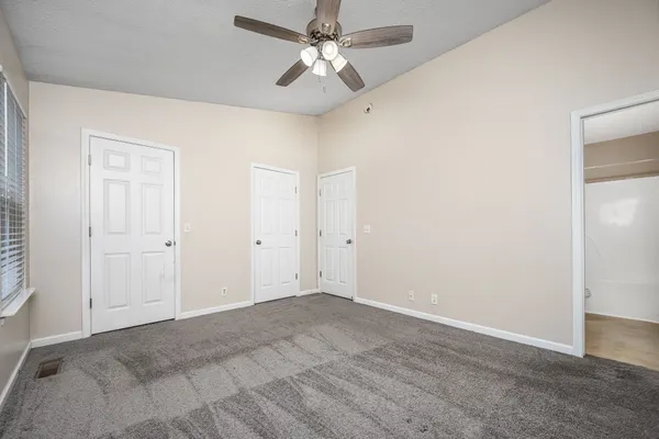 an empty room with fan and a ceiling fan