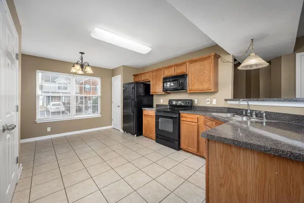 a kitchen with stainless steel appliances granite countertop a stove sink and cabinets