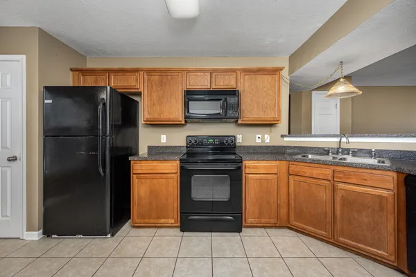a kitchen with granite countertop stainless steel appliances and wooden cabinets