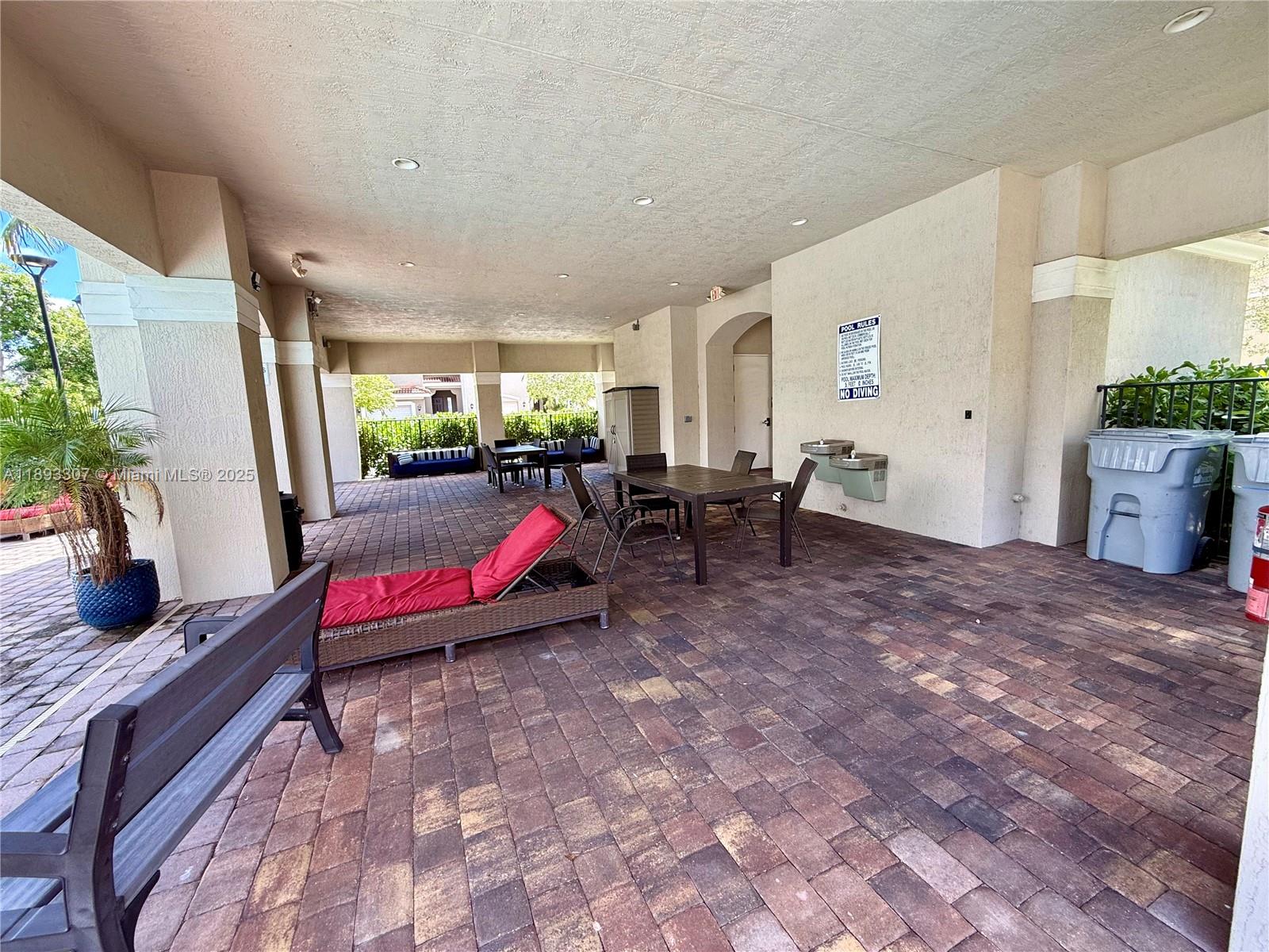 1075 Northwest 33rd Manor Pompano Beach, FL 33064 - Photo 26 of 27 a living room with furniture and a floor to ceiling window