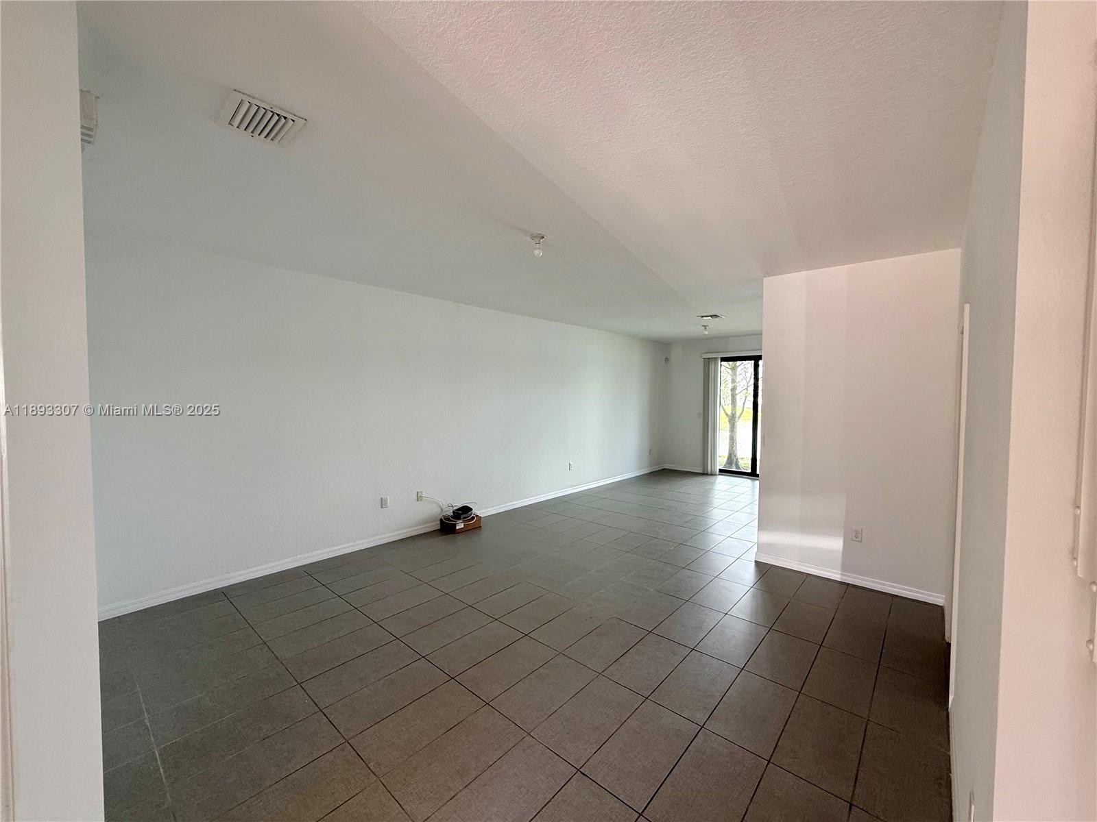 1075 Northwest 33rd Manor Pompano Beach, FL 33064 - Photo 3 of 27 an empty room with windows