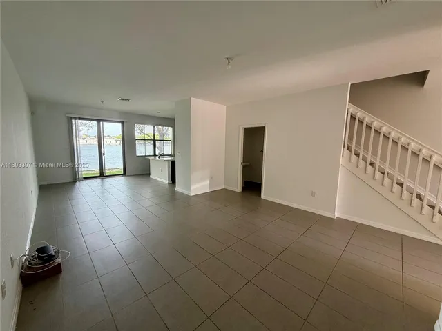 a view of hallway with stairs and a couch