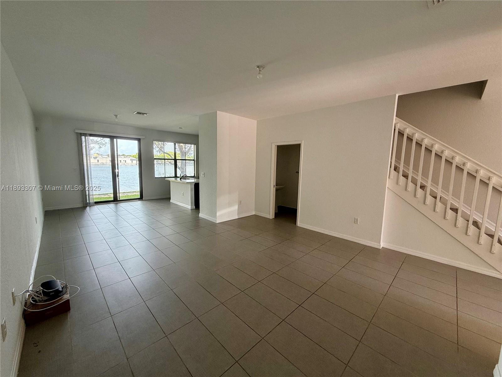 1075 Northwest 33rd Manor Pompano Beach, FL 33064 - Photo 4 of 27 a view of hallway with stairs and a couch