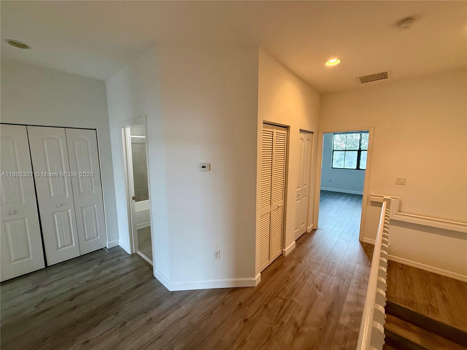 1075 Northwest 33rd Manor Pompano Beach, FL 33064 - Photo 10 of 27 a view of a hallway with wooden floor